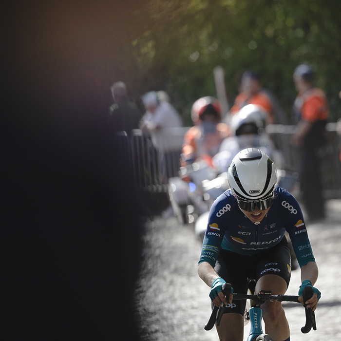 Ronde van Vlaanderen Vrouwen 2025 - Magdalene Lind of Team Coop - Repsol is framed to one side by the crowd as she approaches Taaienberg