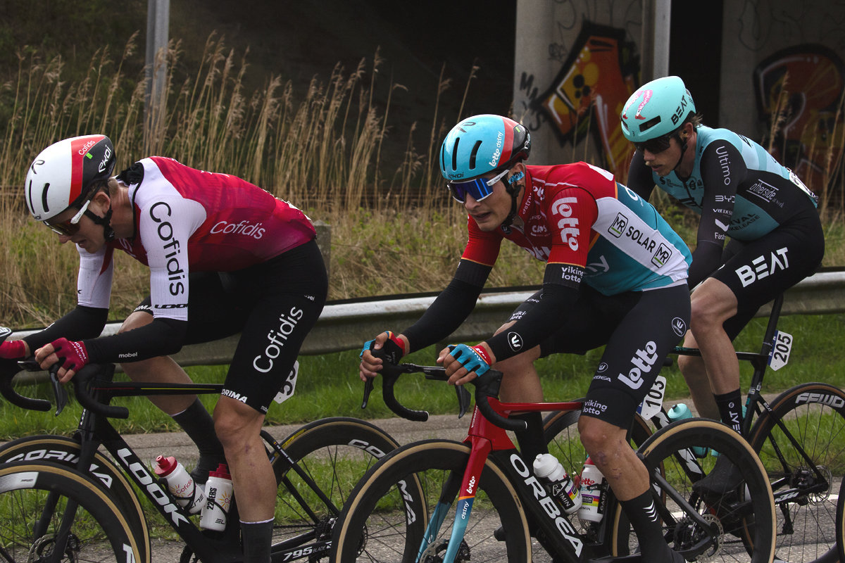 Scheldeprijs 2024 - Riders pass in front of graffiti covered walls in Rilland