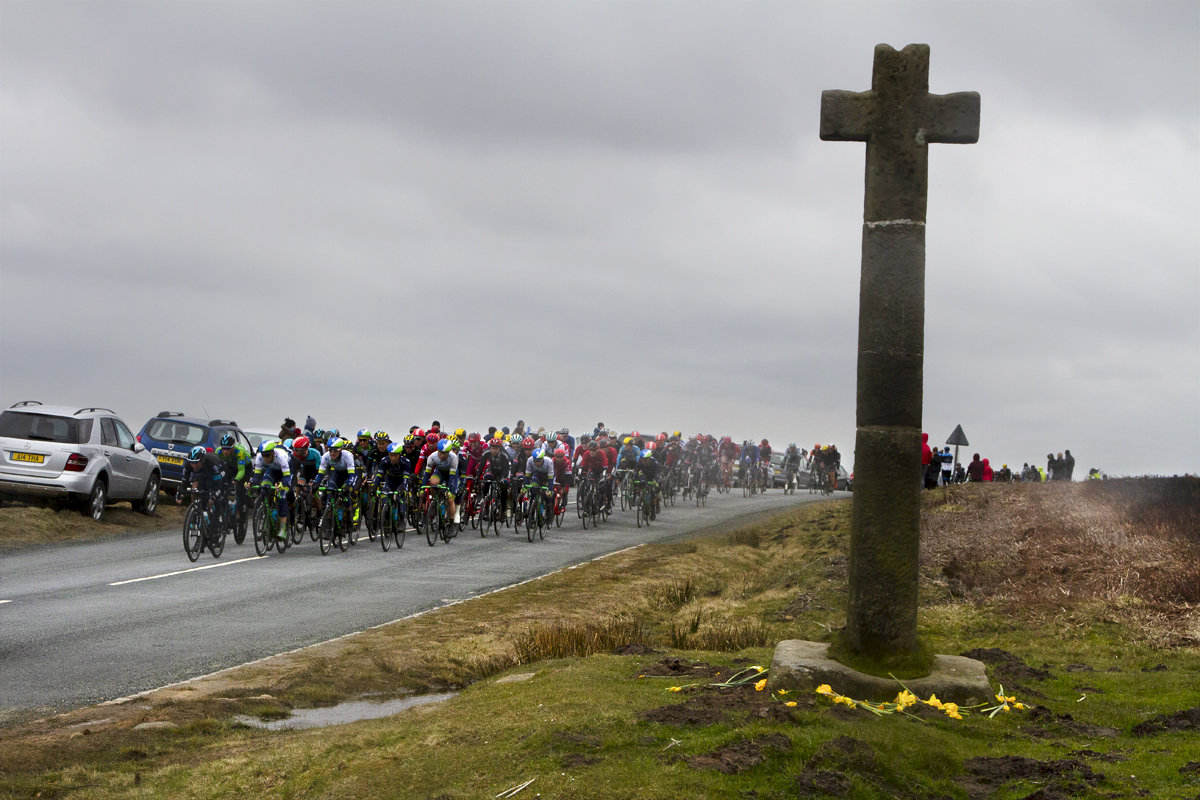 Tour de Yorkshire 2016 -The peloton passes by Ralph’s Cross on the North York Moors