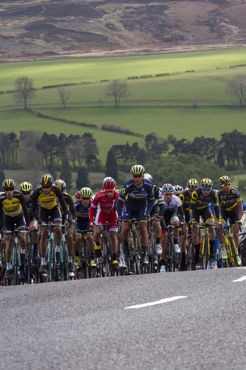 Tour de Yorkshire 2017 - the peloton climbs the hill at Goathland with the Yorkshire countryside as a backdrop