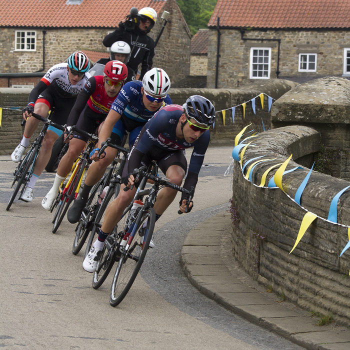 Tour de Yorkshire 2017 - A group of riders cross the bridge at West Tanfield