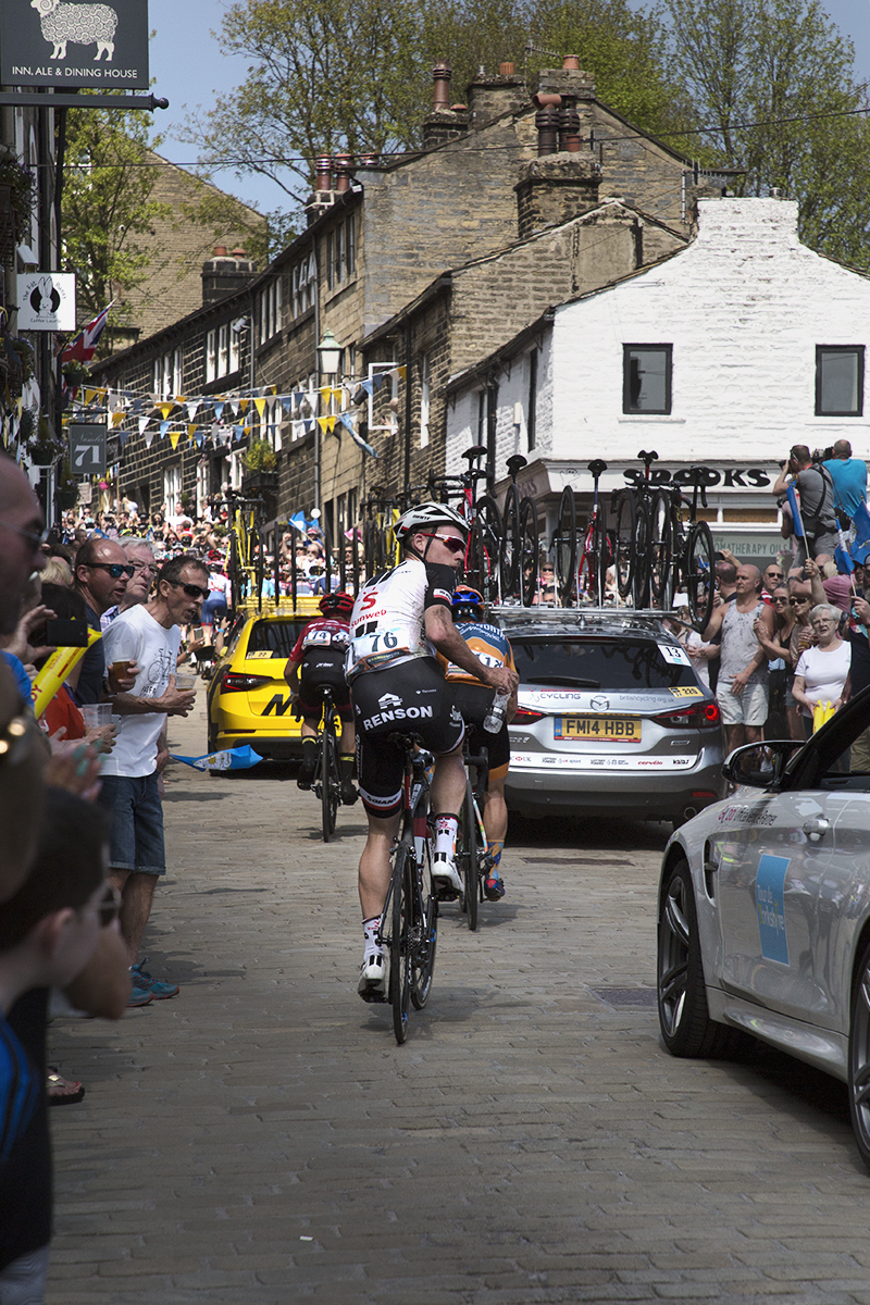 Tour de Yorkshire 2018 - Mike Teunissen looks for his support car as he climbs a packed hill in Haworth