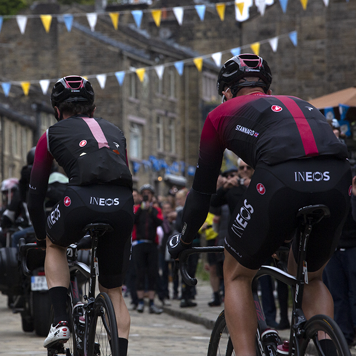 Tour de Yorkshire 2019 - Rear shot of INEOS riders making their way onto the climb in Haworth with Tour de Yorkshire bunting visible