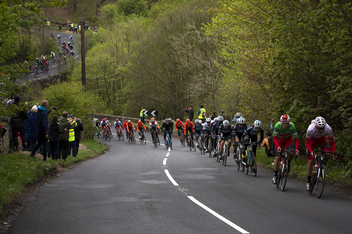 Tour de Yorkshire 2019 - A strung out peloton ascends Pot Bank - Harrogate