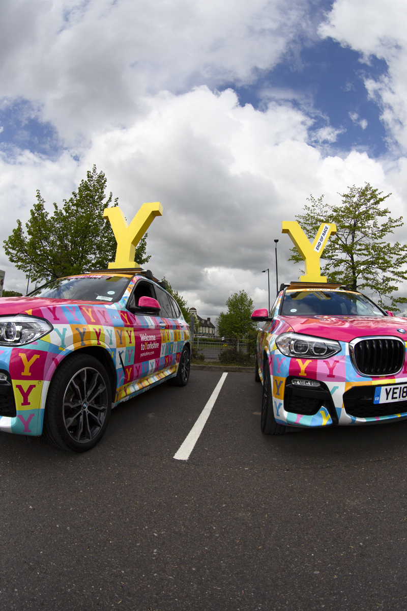 Tour de Yorkshire 2019 - Welcome to Yorkshire cars with large yellow Ys on their roof