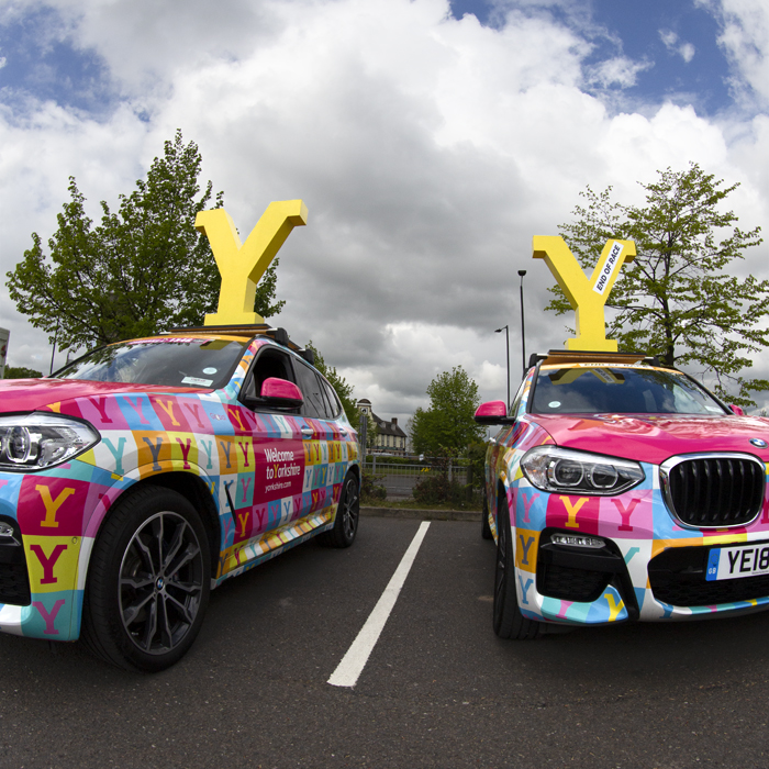 Tour de Yorkshire 2019 - Welcome to Yorkshire cars with large yellow Ys on their roof