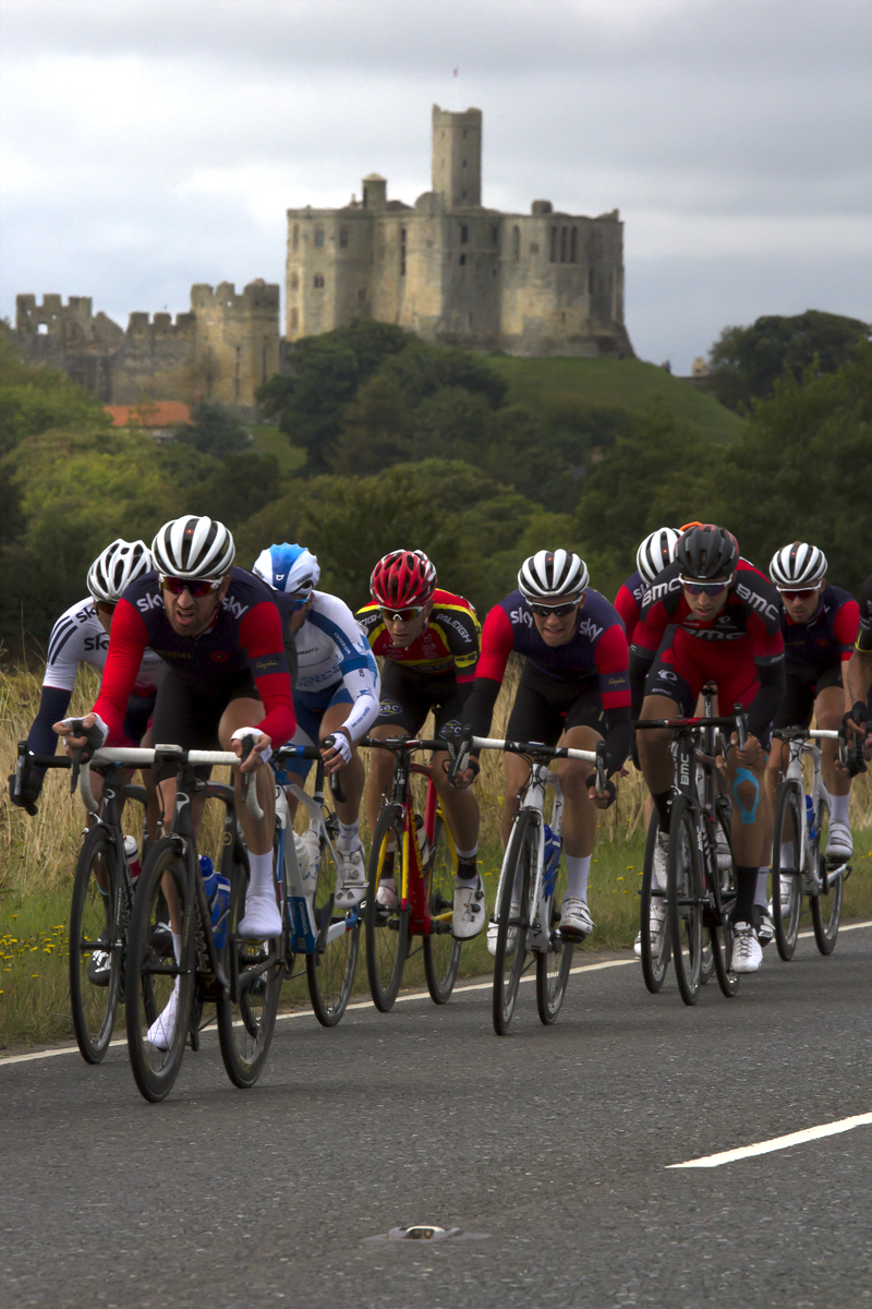 Tour of Britain 2015 - Bradley Wiggins leads a group with Warkworth Castle in the background