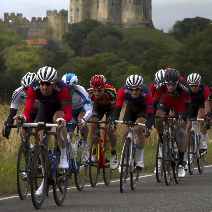 Tour of Britain 2015 - Bradley Wiggins leads a group with Warkworth Castle in the background