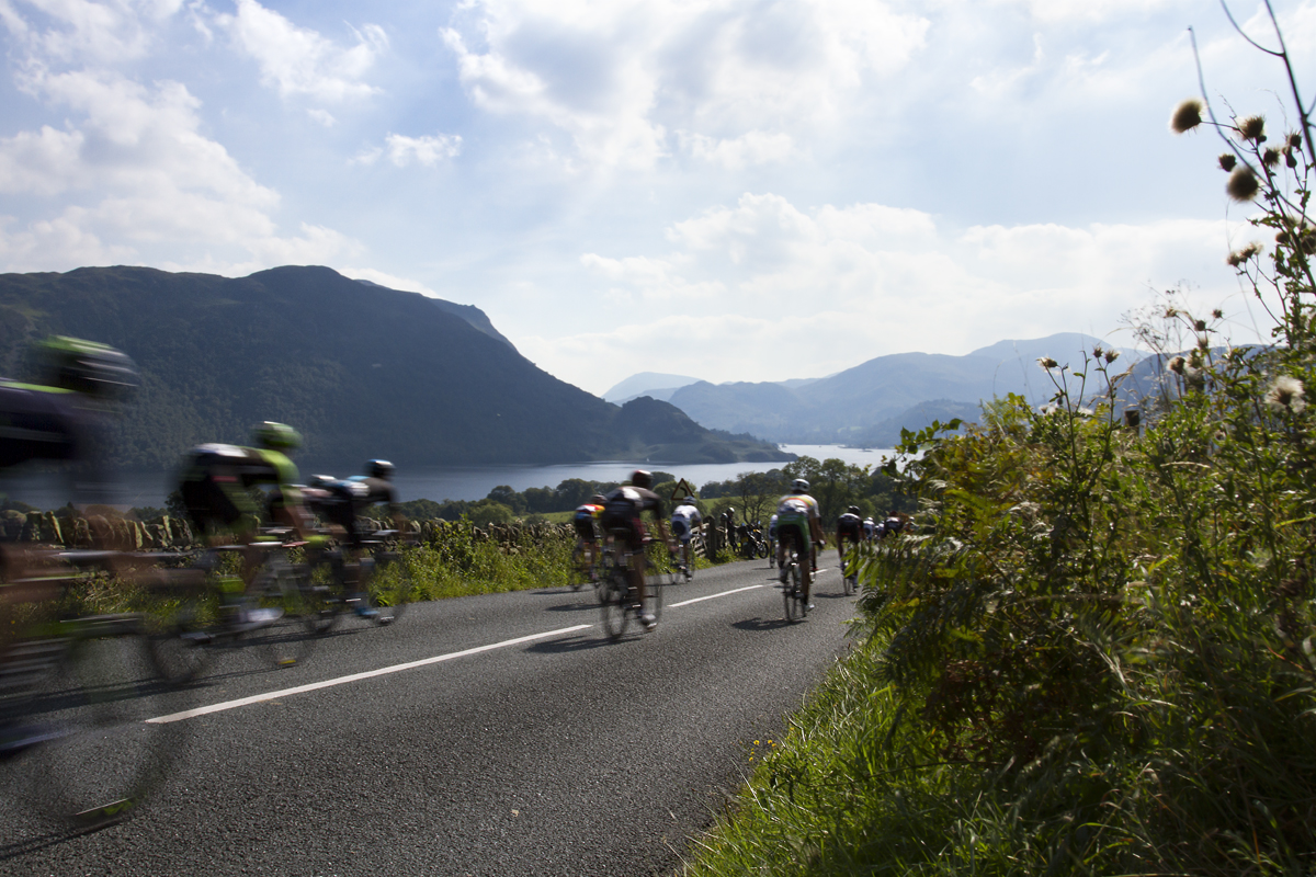 Tour of Britain 2015 - riders descend towards Ullswater with the fells of the Lake District in the distance