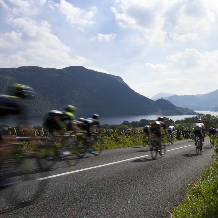 Tour of Britain 2015 - riders descend towards Ullswater with the fells of the Lake District in the distance