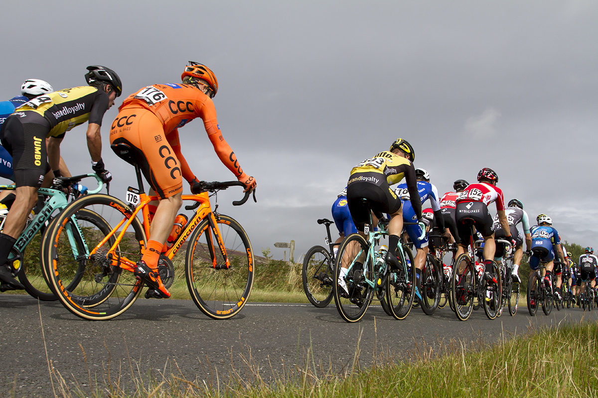 Tour of Britain 2017 - The peloton on a moorland road in Northumberland