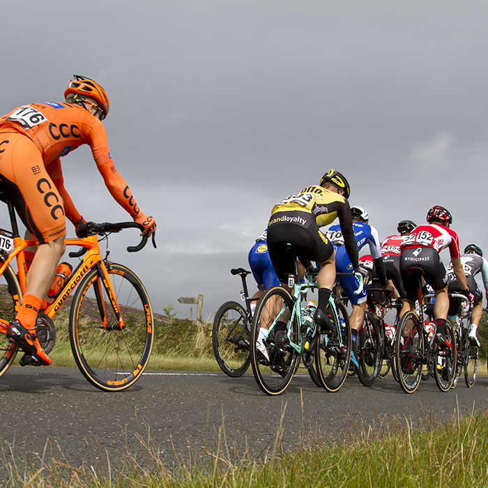 Tour of Britain 2017 - The peloton on a moorland road in Northumberland