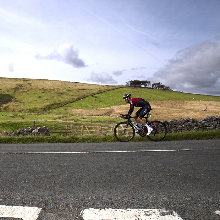 Tour of Britain 2019 - Dylan van Baarle passes by dry stone walls and hilly countryside near Sedburgh