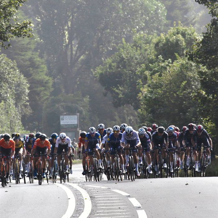 Tour of Britain 2021 - The peloton climbs the hill on the way into Bodmin