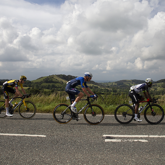 Tour of Britain 2021 - Riders pass through The Peak District with Blaze Hill in the background