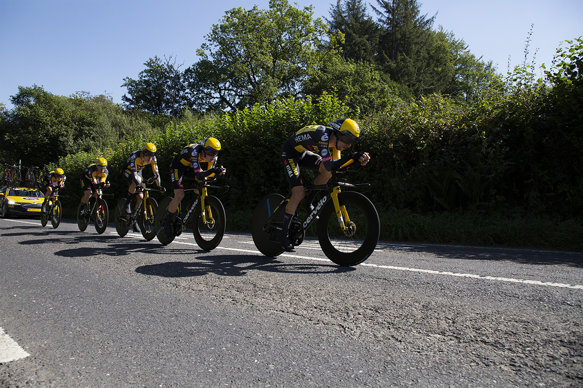 Tour of Britain 2021 - Team Time Trial - Team Jumbo-Visma are followed closely by their support vehicle as they pass down a hedge lined road