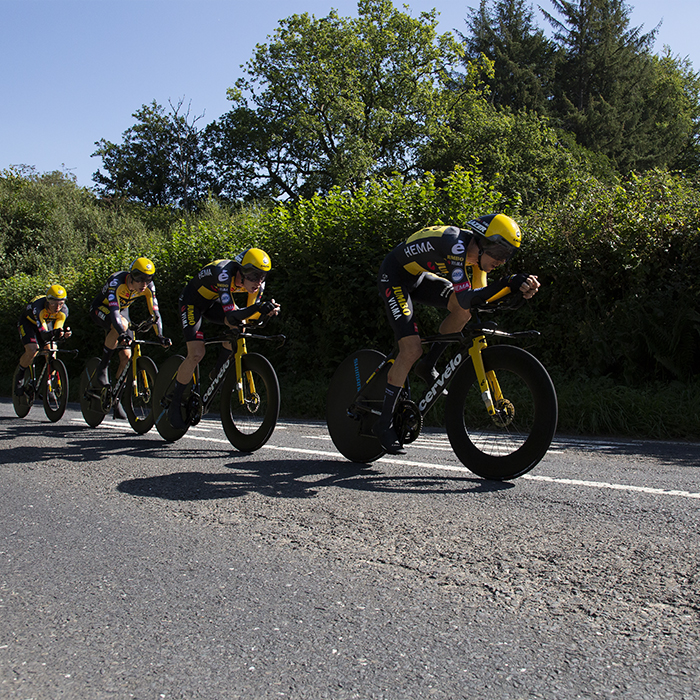 Tour of Britain 2021 - Team Time Trial - Team Jumbo-Visma are followed closely by their support vehicle as they pass down a hedge lined road