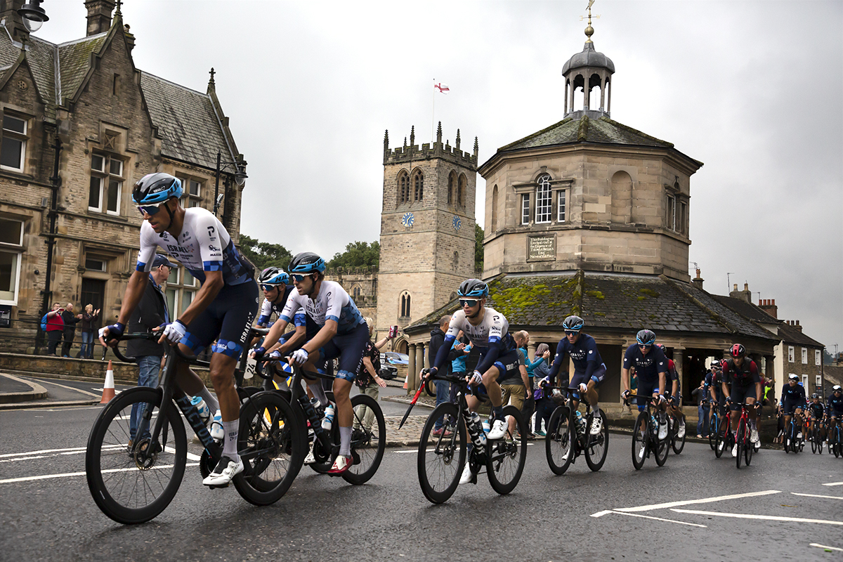 Tour of Britain 2022 - Israel Premier Tech lead the peloton past the Market Cross in Barnard Castle