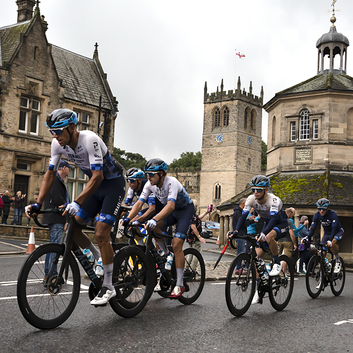 Tour of Britain 2022 - Israel Premier Tech lead the peloton past the Market Cross in Barnard Castle