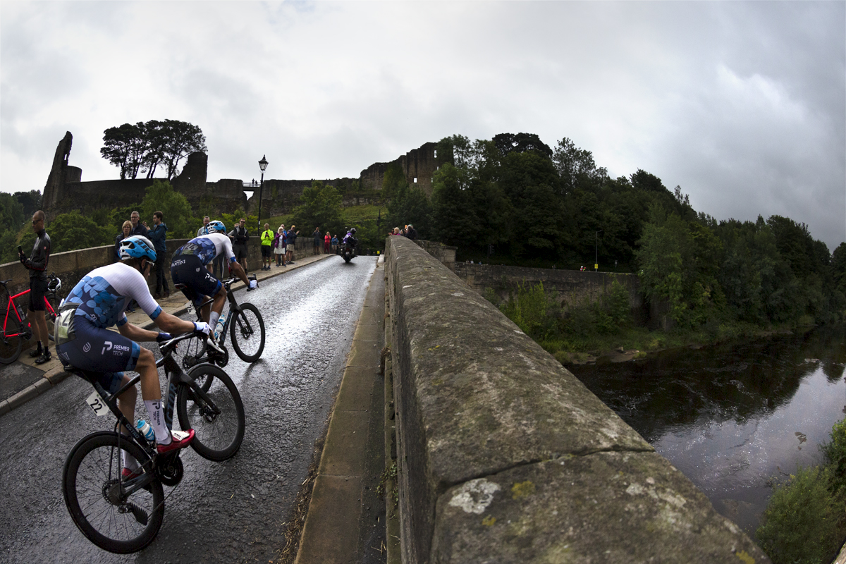 Tour of Britain 2022 - Alex Dowsett of Israel - Premier Tech races over the bridge with Barnard Castle clearly visible in the background