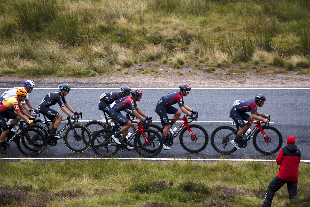 Tour of Britain 2022 - INEOS Grenadiers pass a fan at the side of the Cairnwell Pass on the way to the finish of Stage 1