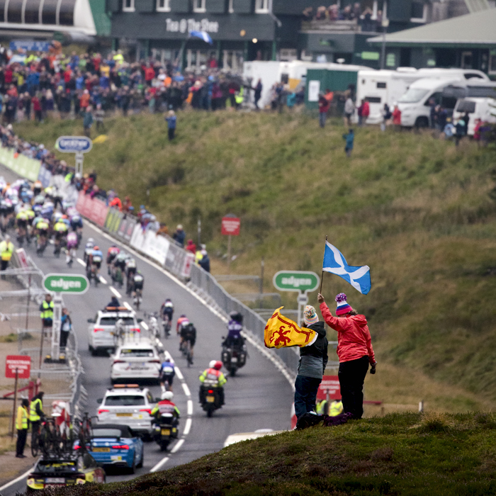 Tour of Britain 2022 - Two fans wave Scottish Flags from a hill top as they view the race approaching the finish line at Glenshee Ski Centre