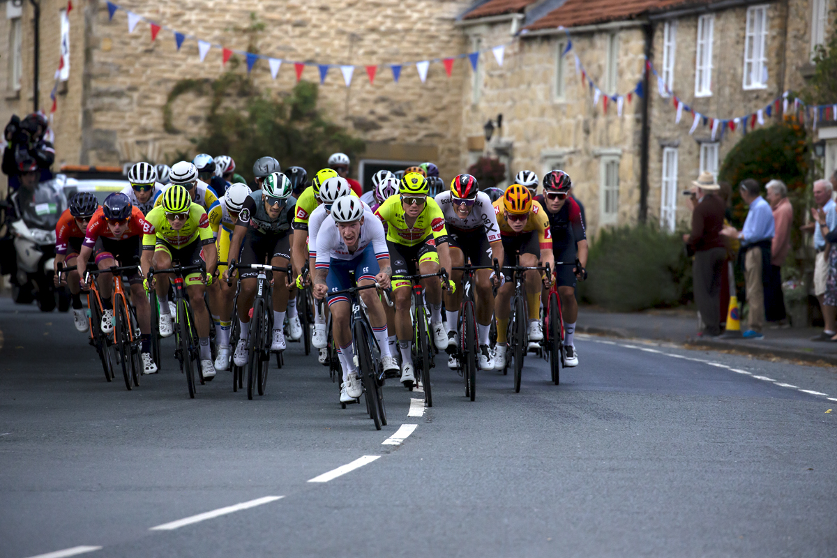 Tour of Britain 2022 - Jake Stewart leads the chase group through the streets of Helmsley in Yorkshire