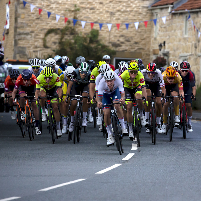 Tour of Britain 2022 - Jake Stewart leads the chase group through the streets of Helmsley in Yorkshire