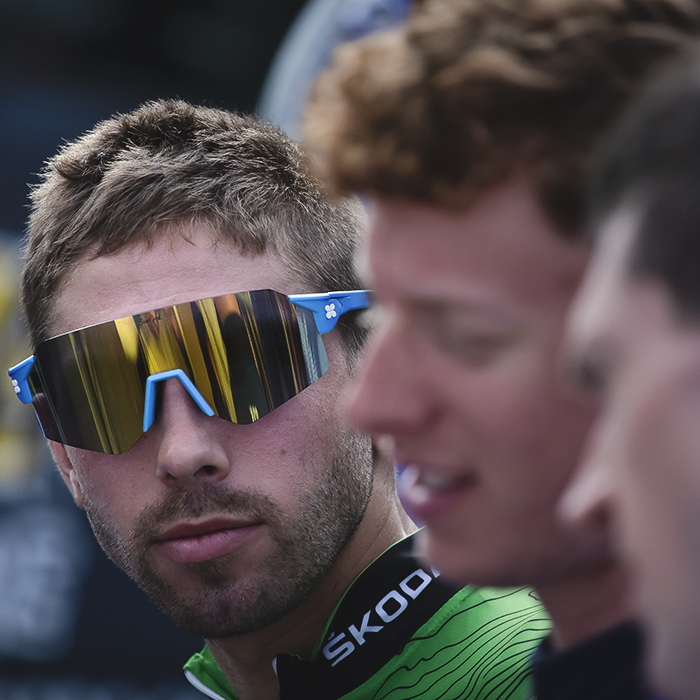 Tour of Britain 2022 - Jacob Scott of WiV SunGod in sunglasses looks past his team mates towards the camera