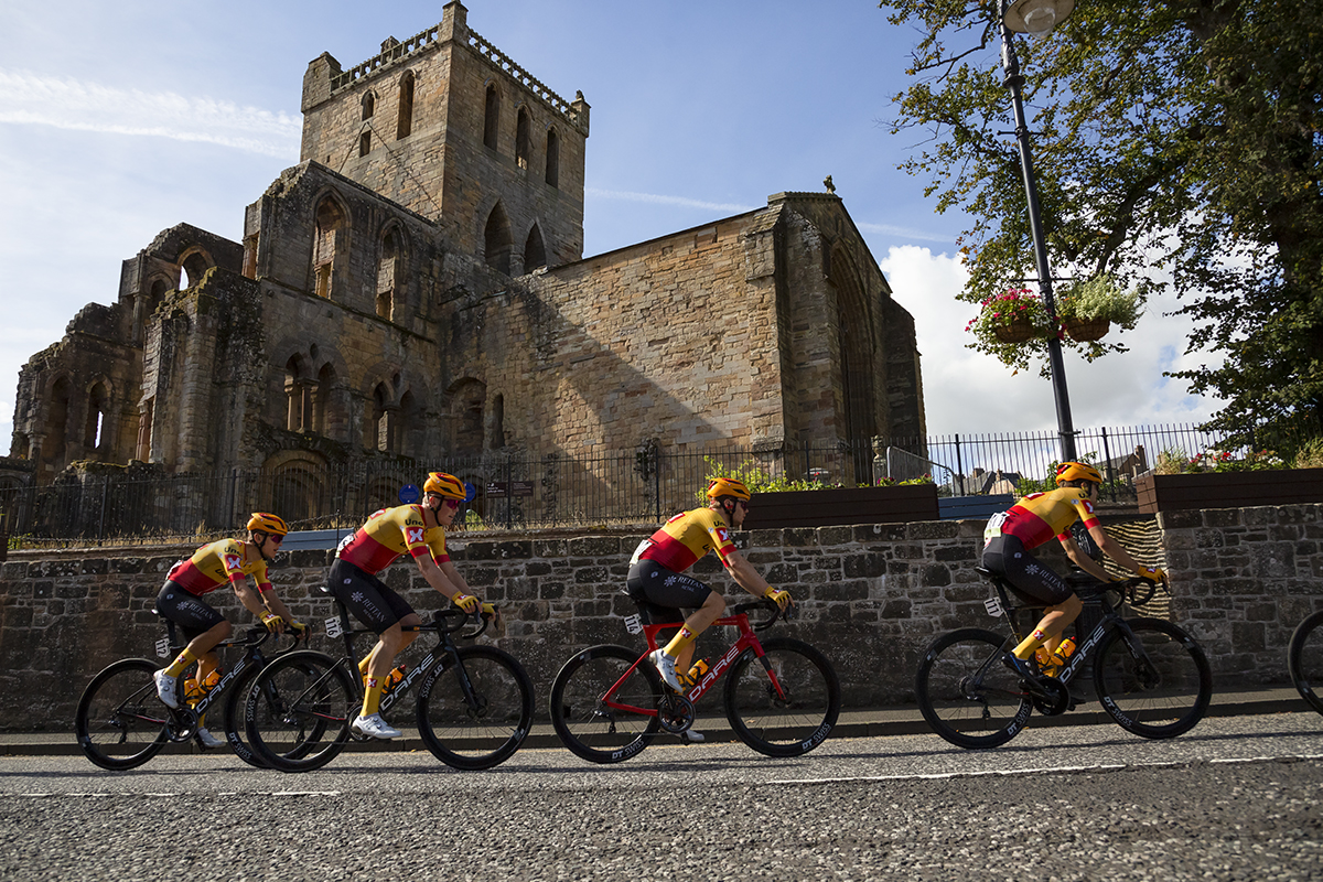 Tour of Britain 2022 - Uno-X Pro Cycling Team pass Jedburgh Abbey