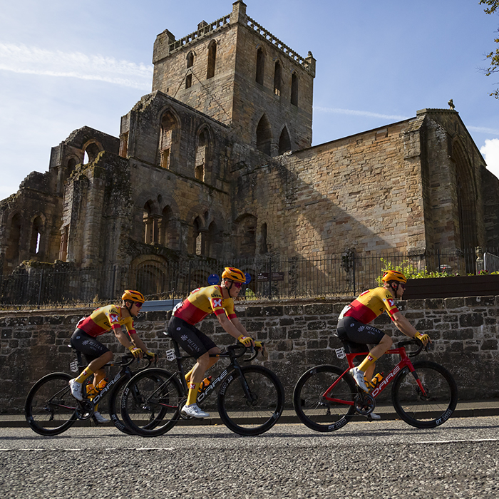 Tour of Britain 2022 - Uno-X Pro Cycling Team pass Jedburgh Abbey