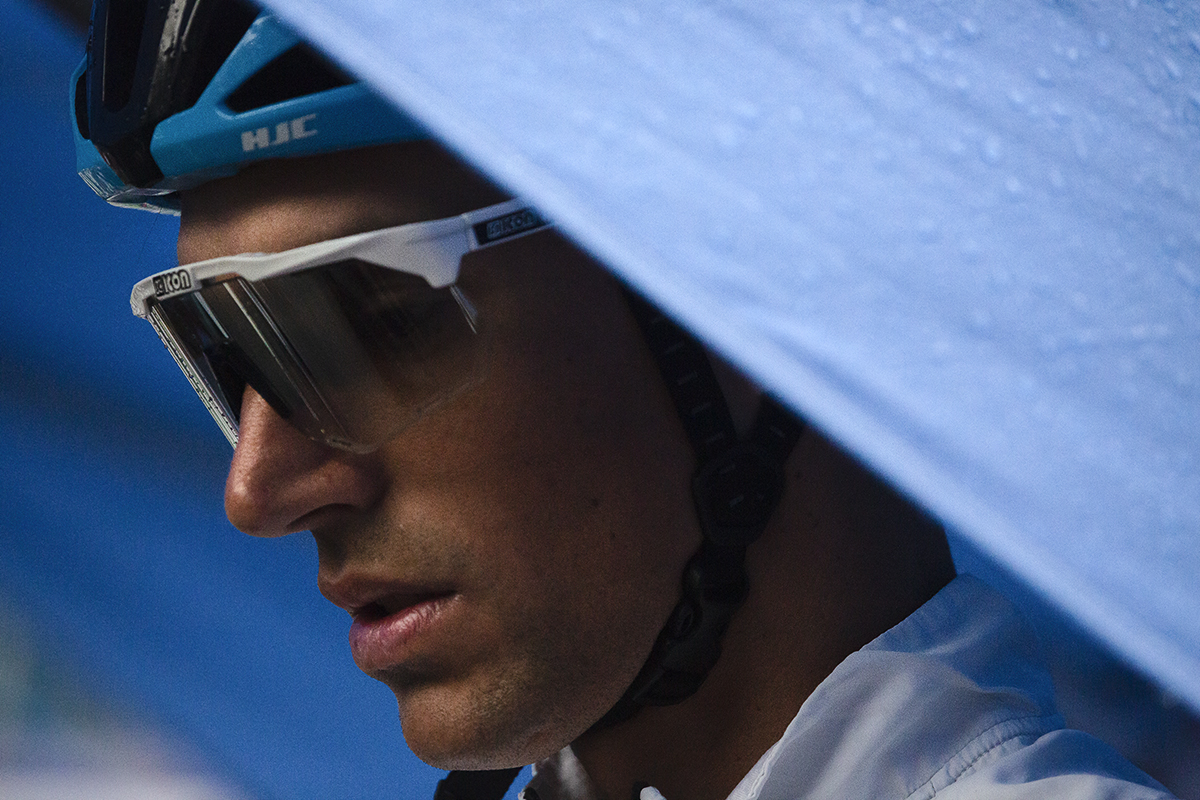 Tour of Britain 2022 - Reto Hollenstein of Israel - Premier Tech shelters under a blue gazebo before signing on at the Tour of Britain in Aberdeen