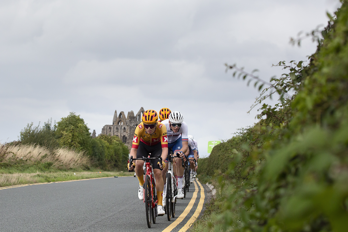 Tour of Britain 2022 - Uno-X Pro Cycling Team lead the breakaway with Whitby Abbey in the background