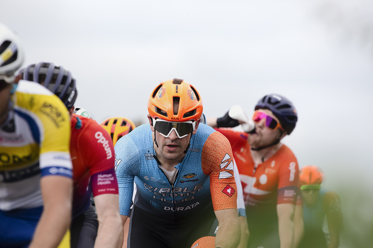 Tour of Britain 2022 - Ross Lamb of Ribble Weldtite Pro Cycling rides near Whitby Abbey while a rider drinks from a bidon behind him