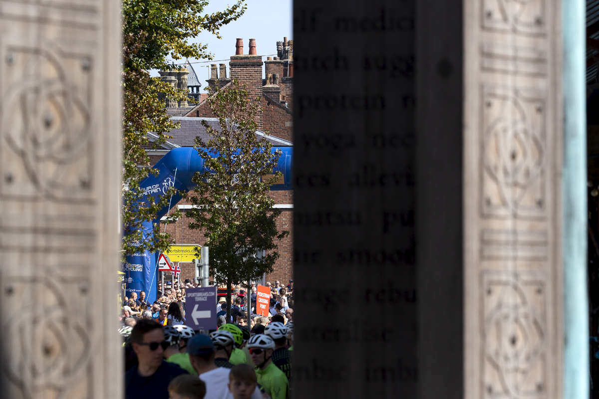 Tour of Britain 2023 - The race start line can be seen through the carved wooden pillars of Altrincham Market