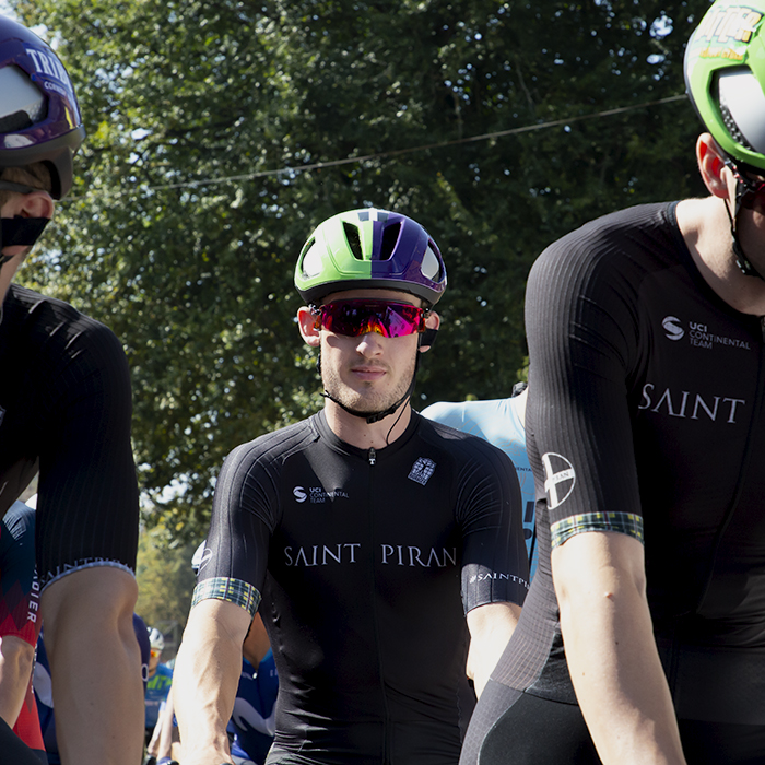 Tour of Britain 2023 - Harry Birchill of Saint Piran is framed by two of his team mates on the start line