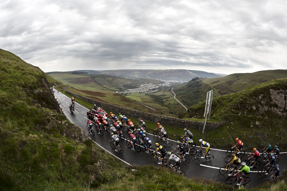 Tour of Britain 2023 - Riders on Bwlch Mountain with a view of the valley below