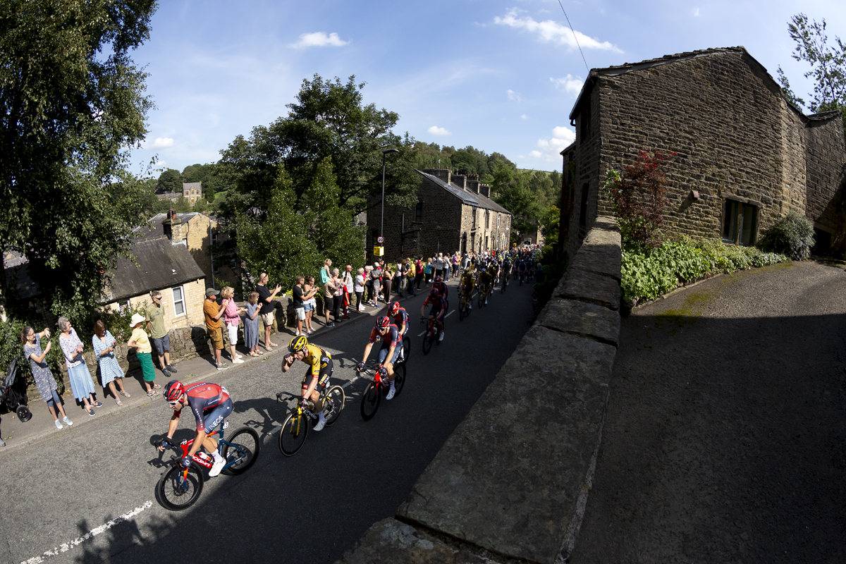 Tour of Britain 2023 - Riders make their way out of Delph with spectators lining the road