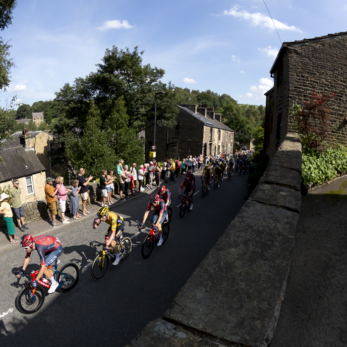 Tour of Britain 2023 - Riders make their way out of Delph with spectators lining the road