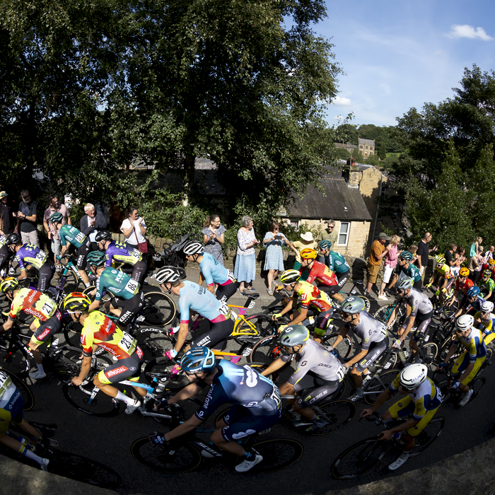 Tour of Britain 2023 - The peloton passes crowds on the way out of Delph