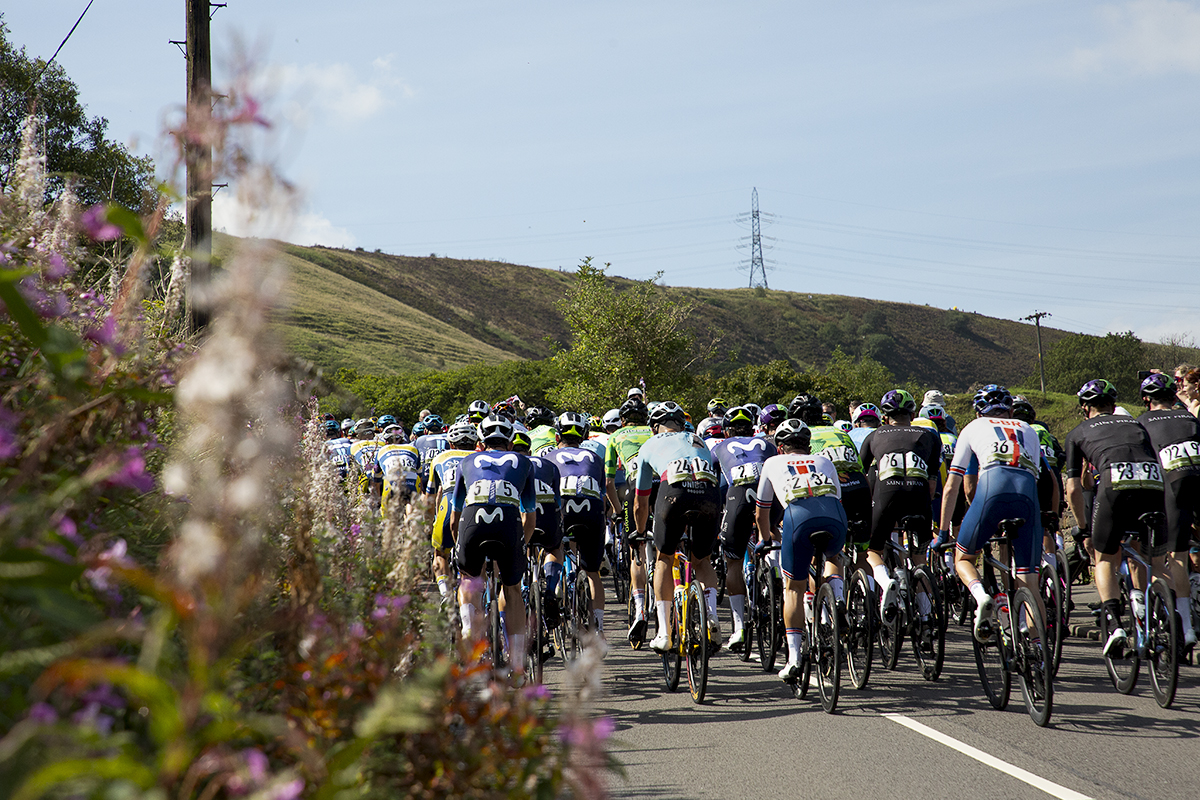 Tour of Britain 2023 - The rear of the peloton as it continues its ascent of Grains Bar