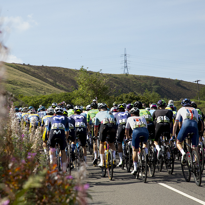 Tour of Britain 2023 - The rear of the peloton as it continues its ascent of Grains Bar