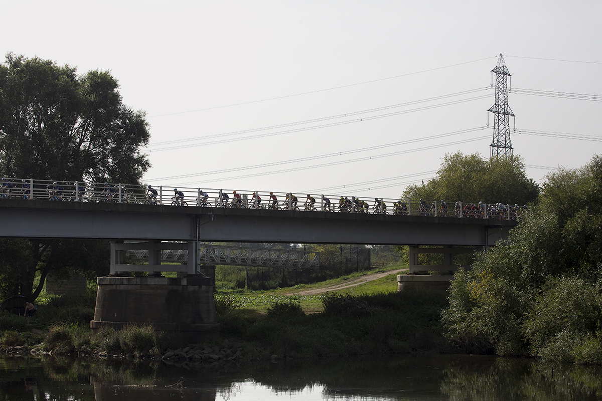 Tour of Britain 2023 - Riders silhouetted against the sky ride across Dunham Toll Bridge