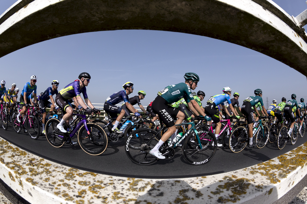 Tour of Britain 2023 - Riders from the side through the barriers at Dunham Toll Bridge