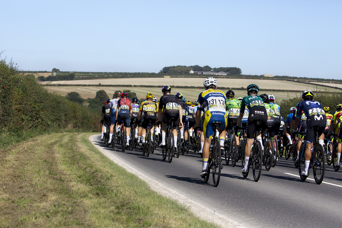 Tour of Britain 2023 - Rear view of the peloton passing through the Yorkshire Wolds