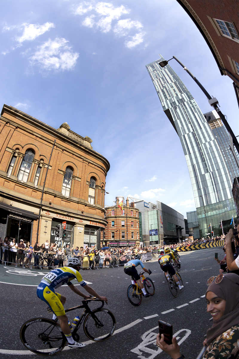 Tour of Britain 2023 - Riders round the corner near the Beetham Tower in Manchester on their way to the finish straight