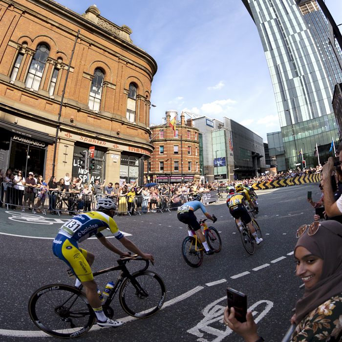 Tour of Britain 2023 - Riders round the corner near the Beetham Tower in Manchester on their way to the finish straight