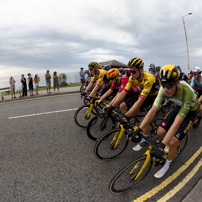 Tour of Britain 2023 - The peloton moves down the sea front in a block