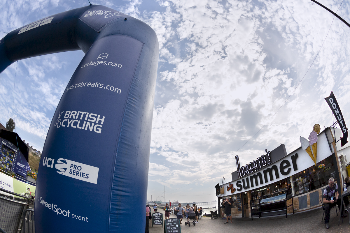 Tour of Britain 2023 - The start gate for the race near an ice cream stand with the pier in the background