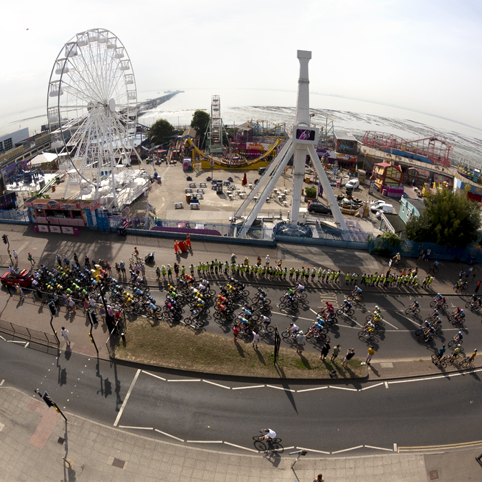 Tour of Britain 2023 - A panoramic shot of the race moving down the sea front